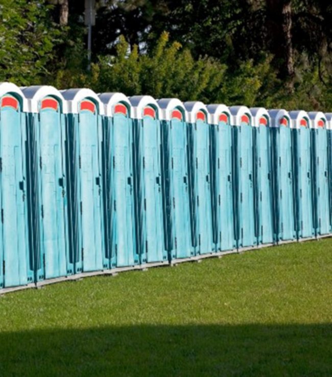 Multiple blue-colored portable toilets for rent for outdoor events in New York & New Jersey